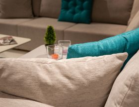 Stylish indoor living room with a modern sofa, colorful pillows, and home decor.