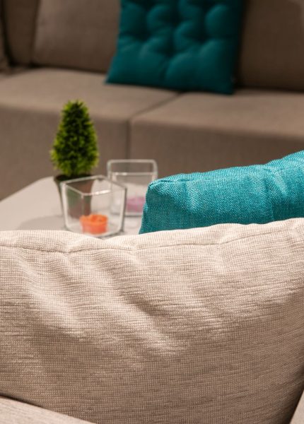 Stylish indoor living room with a modern sofa, colorful pillows, and home decor.