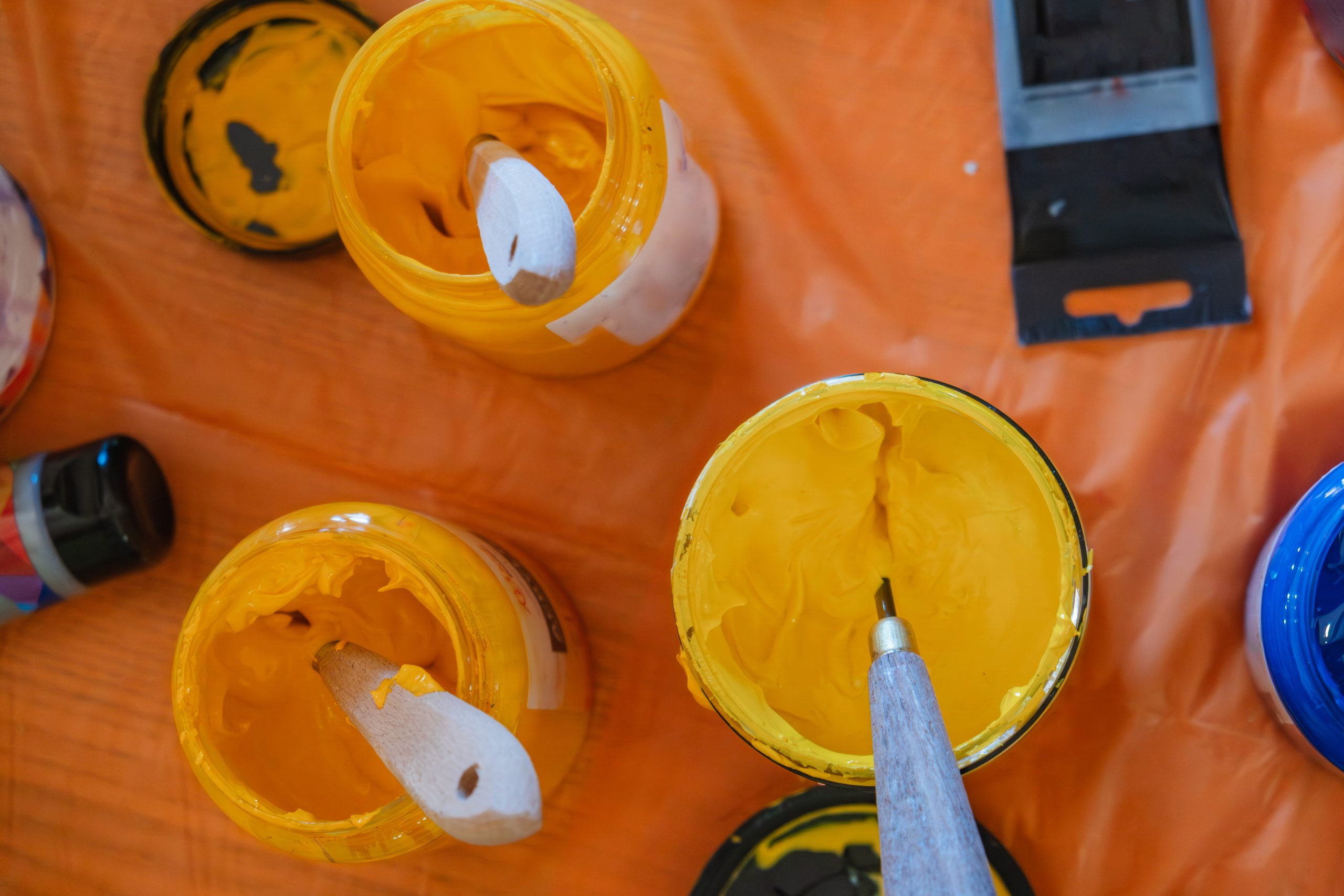Bright jars of yellow and blue paint