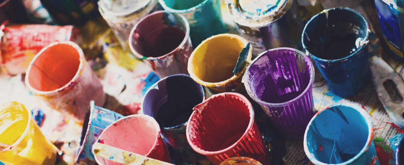 Colorful paints and cups background texture