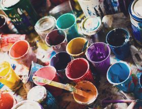 Colorful paints and cups background texture