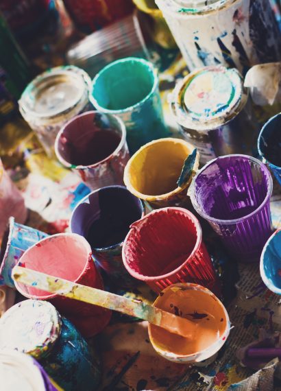 Colorful paints and cups background texture
