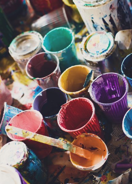 Colorful paints and cups background texture