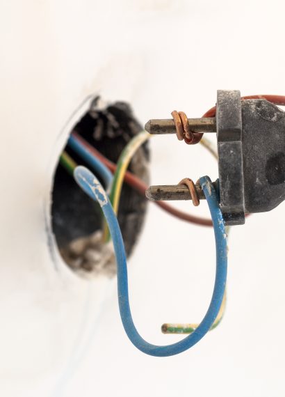 Exposed electrical wiring and plug close up