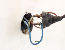 Exposed electrical wiring and plug close up