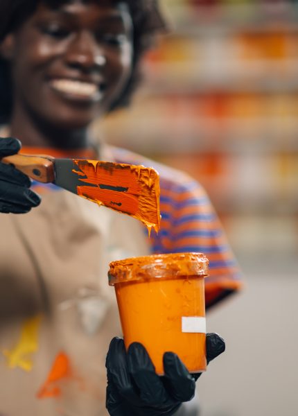 Interracial printing shop worker mixing paint for