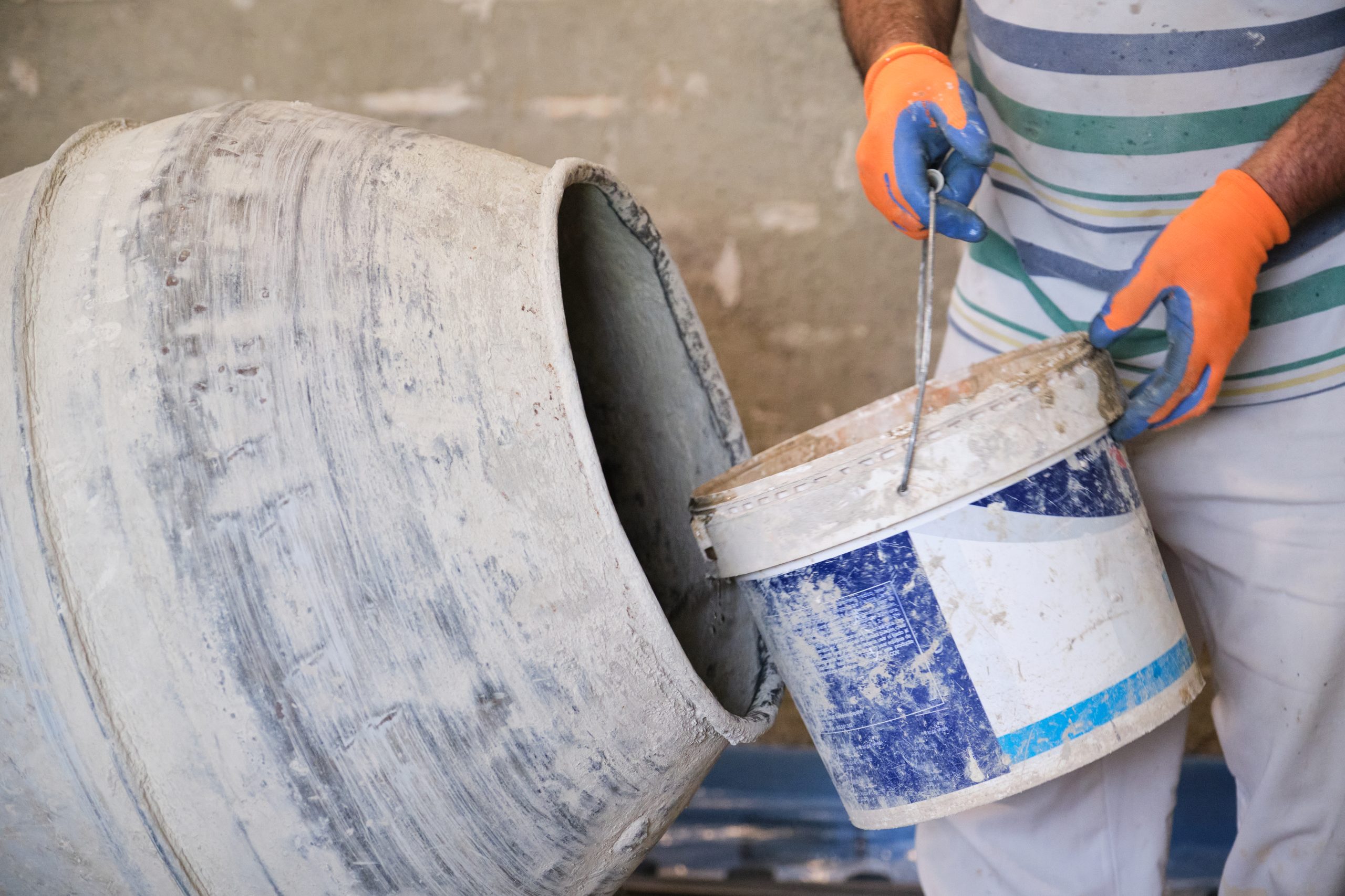 Mixing cement by cement mixer in construction site