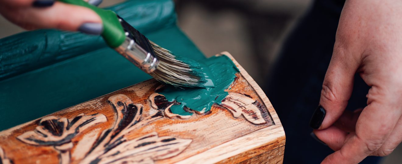 Painting carved wood decoration with teal green pa