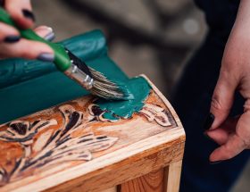 Painting carved wood decoration with teal green pa