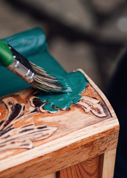 Painting carved wood decoration with teal green pa
