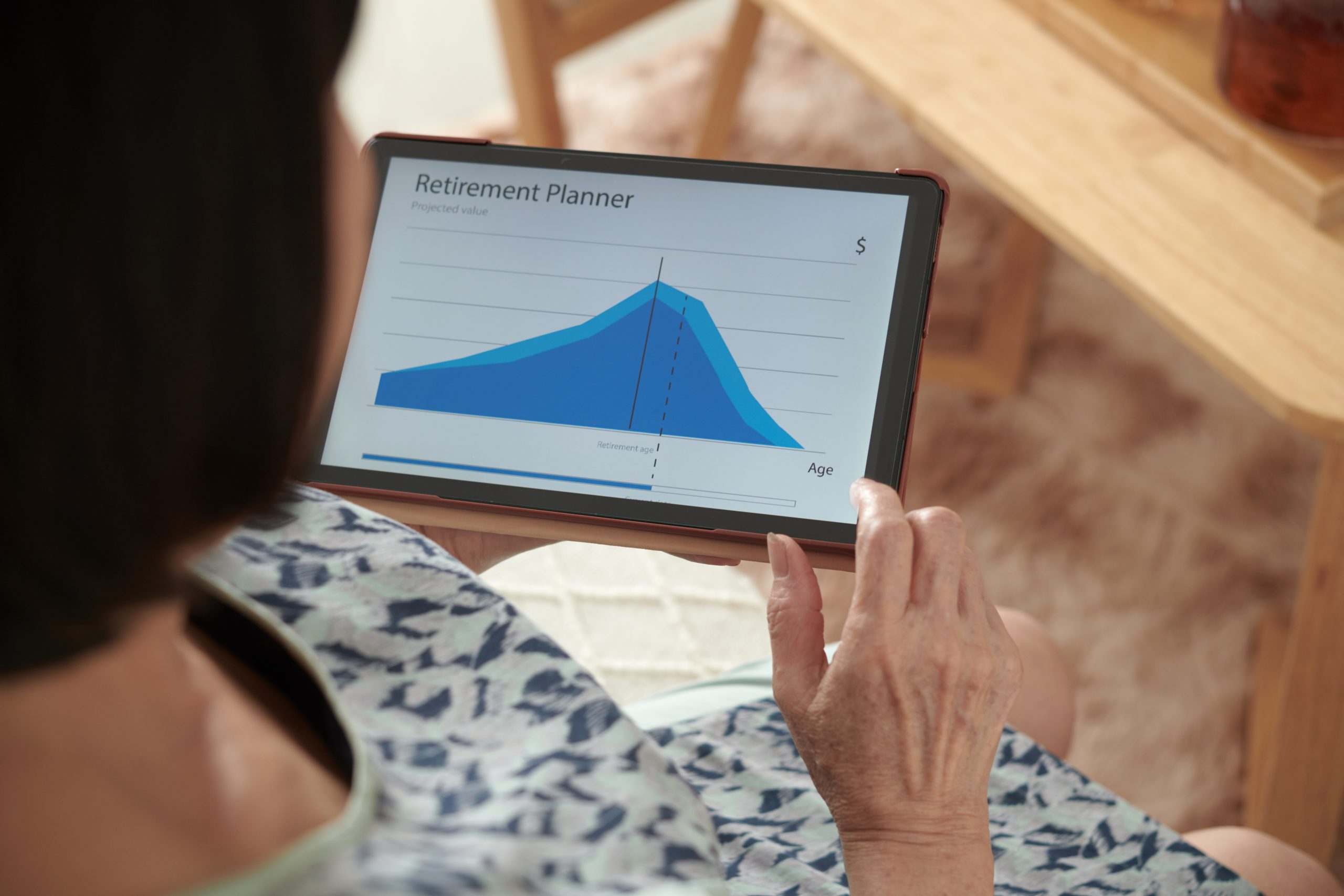 Senior woman planning retirement finances with tab