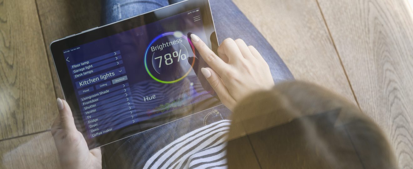 Woman using tablet for smart home automation