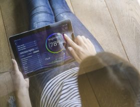 Woman using tablet for smart home automation