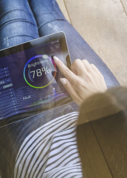Woman using tablet for smart home automation
